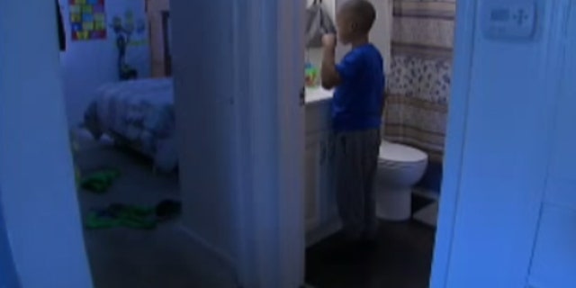 Justice McDonald, 8, keeps a bottle of water nearby so he could clean up and brush his teeth every morning.