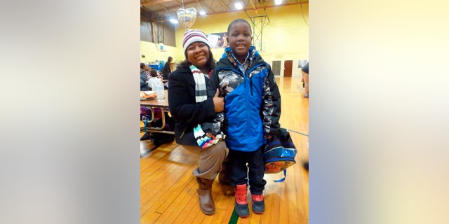 Sherri Miller and her son, Jameer, 7, are seen at Freeman Elementary School where Jameer was getting his finger-prick blood sample tested for lead.