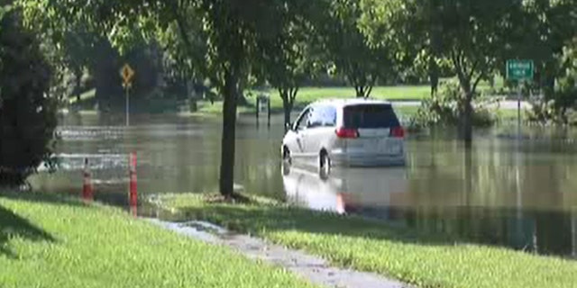The minivan became trapped in floodwaters Tuesday.