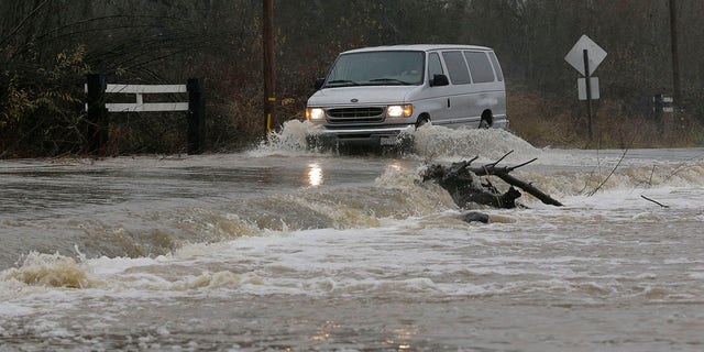 Jan. 7, 2017: A van drives through flooded water on Green Valley Road in Graton, Calif.