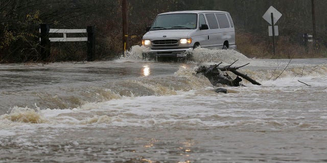 Jan. 7, 2017: A van drives through flooded water on Green Valley Road in Graton, Calif.