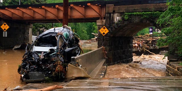 Cars were left destroyed after floodwaters rushed through the streets in Maryland's Ellicott City.