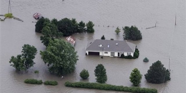 June 13: A home is engulfed by flood water in Hamburg, Iowa. The rising Missouri River has ruptured two levees in northwest Missouri, sending torrents of floodwaters over rural farmland toward the Iowa town of Hamburg and the Missouri resort town of Big Lake.