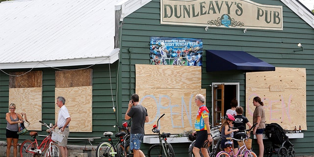 Dunleavy's Pub on Sullivan's Island, South Carolina wrote "open" on their boarded up windows.