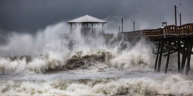Waves slam the Oceana Pier & Pier House Restaurant in Atlantic Beach, North Carolina on Thursday as Hurricane Florence approached the area.