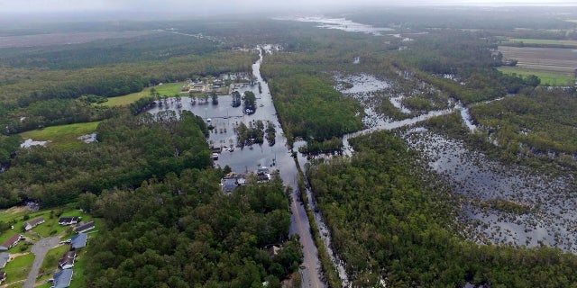 Floodwaters surround homes in the aftermath of Hurricane Florence in Newport, N.C., Monday, Sept. 17, 2018.