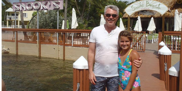 A man and a girl pose in this photo recovered from the missing camera.