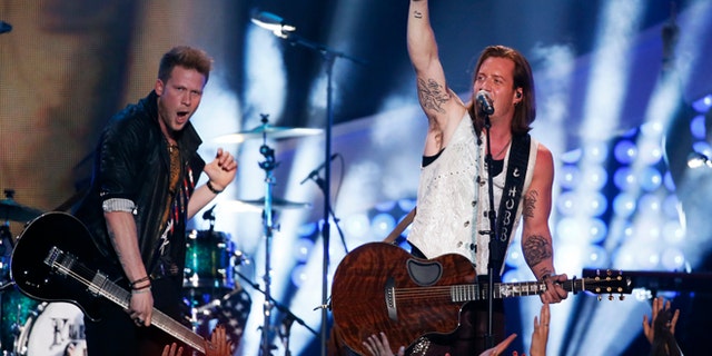 Brian Kelley (L) and Tyler Hubbard of Florida Georgia Line perfom "Stay" during the 4th annual American Country Awards in Las Vegas, Nevada December 10, 2013. REUTERS/Lucy Nicholson (UNITED STATES - Tags: ENTERTAINMENT) - RTX16DAR