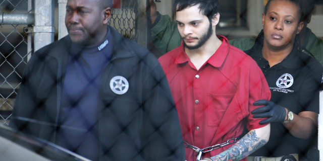 Law enforcement officers escort Esteban Santiago, the suspect in a deadly 2017 shooting at Fort Lauderdale-Hollywood International Airport in Florida.
