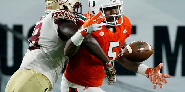 Miami Hurricanes tight end Standish Dobard (5) can't hold on to the ball as Florida State linebacker Ro'Derrick Hoskins (18) defends during the second half of an NCAA college football game, Saturday, Oct. 8, 2016, in Miami Gardens. (AP Photo/Wilfredo Lee)