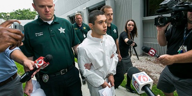 Suspect Sky Bouche said he was sorry while being led by officers.