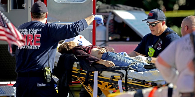 Medical personnel tend to victim following a shooting at Marjory Stoneman Douglas School in Parkland, Florida.