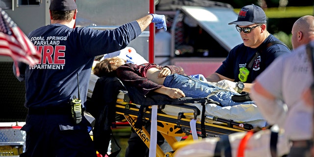 Medical personnel tend to victim following a shooting at Marjory Stoneman Douglas School in Parkland, Florida.