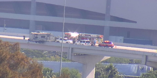 Rescue crews worked to secure a camper hanging from a Florida overpass.