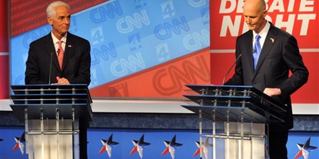 Oct. 21, 2014: Democratic candidate Charlie Crist, left, and Republican Gov. Rick Scott wait for their live televised debate.
