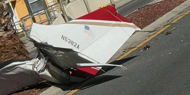 Pieces of a small plane lay on top of a road after small plane crashed in Kissimmee, Fla on Tuesday.