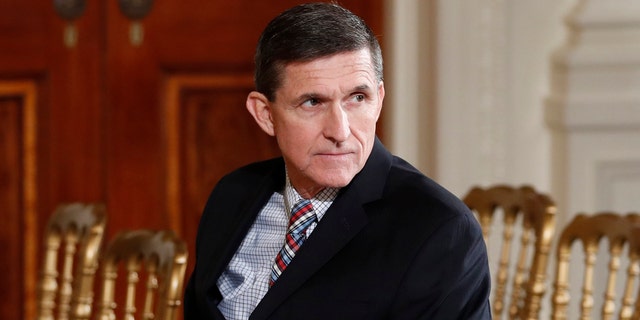 FILE - In this Feb. 10, 2017 file photo, then-National Security Adviser Michael Flynn sits in the East Room of the White House in Washington.  A member of Donald Trump's transition team asked national security officials in the Obama White House for the classified CIA profile on Russia's ambassador to the United States. The unusual request appears to signal that Trump's own team had concerns about whether his pick for national security adviser, Mike Flynn, fully understood that he was dealing with a man rumored to have ties to Russian intelligence agencies. (AP Photo/Carolyn Kaster, File)