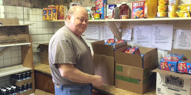 Ronnie Thornsbury, a volunteer at the food pantry, helps pack free meals for more than 1,000 people a month.