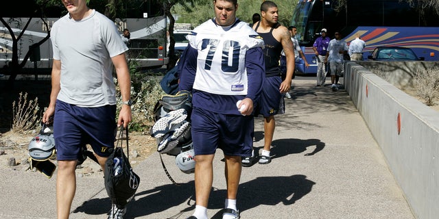 FILE - In this Oct. 24, 2007 file photo, San Diego Chargers' Philip Rivers, left, Shane Olivea (70) and Shawne Merriman, right, arrive for practice with teammates and coaches at the Arizona Cardinals training facility in Tempe, Ariz. Olivea, whose NFL career fell apart because of a painkiller addiction says he wants to become a college coach and help others avoid similar pitfalls now that he's clean and has a degree. (AP Photo/Ross D. Franklin)