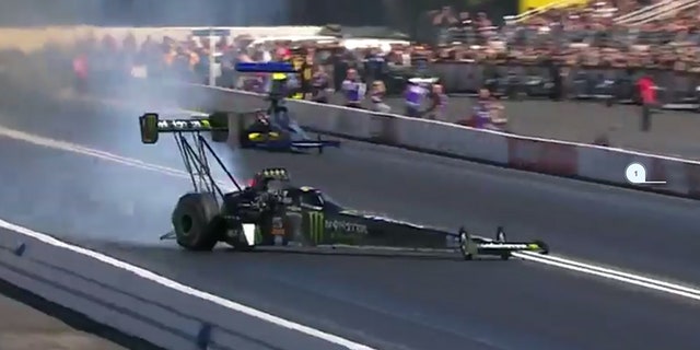 Emergency crews help Force from her Top Fuel dragster.