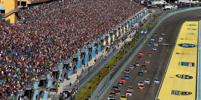 HOMESTEAD, FL - NOVEMBER 16: Jeff Gordon, driver of the #24 Drive To End Hunger Chevrolet, and Kurt Busch, driver of the #41 Haas Automation Chevrolet, lead the field on the first lap of the NASCAR Sprint Cup Series Ford EcoBoost 400 at Homestead-Miami Speedway on November 16, 2014 in Homestead, Florida. (Photo by Brian Lawdermilk/Getty Images)