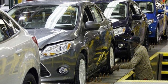 A Ford employee works on the final production line of the 2012 Ford Focus at Michigan Assembly Plant in Wayne, Mich., March 17.