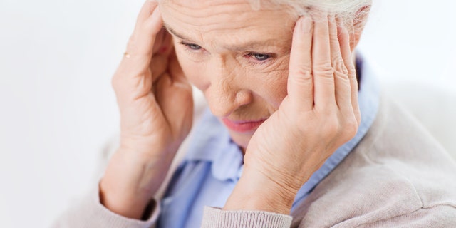 health care, pain, stress, age and people concept - face of senior woman suffering from headache
