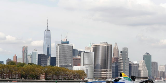 In this Sept. 20, 2016 photo provided by Formula E, a Formula E race car is shown in the Brooklyn borough of New York, with the Manhattan skyline in the background. Formula E, an all-electric racing series, will stage an event next year in Brooklyn. The New York City ePrix double-header will be the first FIA-sanctioned open-wheel race to take place in the five boroughs of New York City. (Formula E via AP)