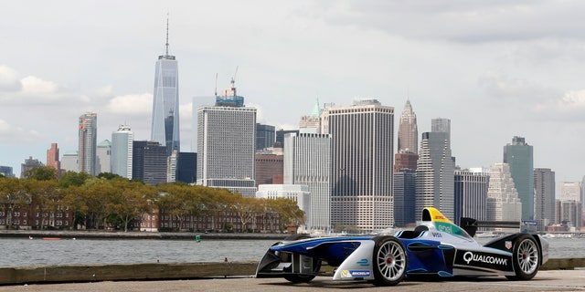 In this Sept. 20, 2016 photo provided by Formula E, a Formula E race car is shown in the Brooklyn borough of New York, with the Manhattan skyline in the background. Formula E, an all-electric racing series, will stage an event next year in Brooklyn. The New York City ePrix double-header will be the first FIA-sanctioned open-wheel race to take place in the five boroughs of New York City. (Formula E via AP)