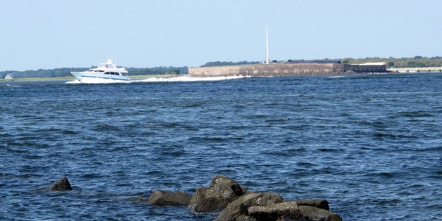 A pleasure boat motors past Fort Sumter in this Friday, Sept. 9, 2016, photograph taken from the beach on Sullivans Island, S.C.