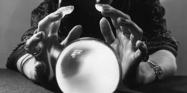 A gypsy fortune-teller gazing into her crystal ball.