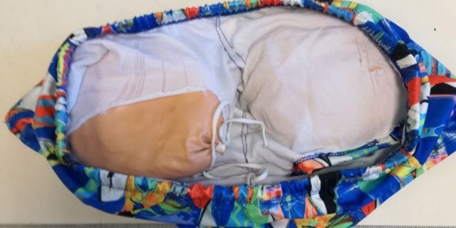 A man used two cushion-like butt implants to try to smuggle more than two pounds of cocaine.