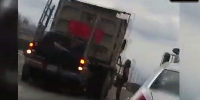 A video shows a naked man running and jumping on multiple vehicles near a roadway outside Washington Dulles International Airport.