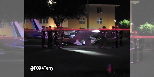 The plane struck a tree before coming to a stop at a light post in the parking lot of an abandoned restaurant.