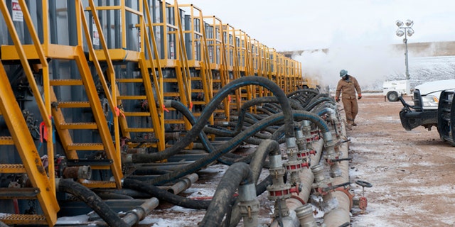 This Nov. 12, 2014 file photo shows water tanks at fracking site near Williston, North Dakota.