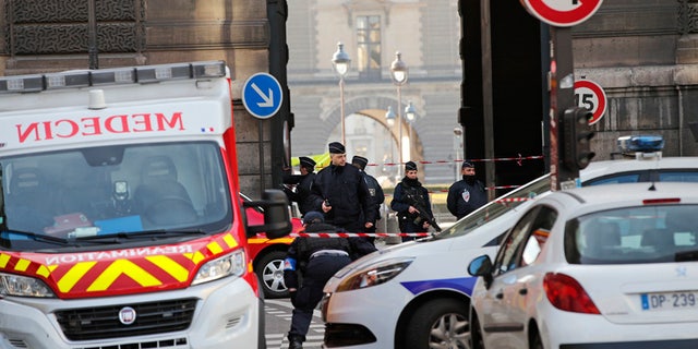 Police officers cordon off the area outside the Louvre museum near where a soldier opened fire after he was attacked in Paris, Friday, Feb. 3, 2017. Police say the soldier opened fire outside the Louvre Museum after he was attacked by someone, and the area is being evacuated. (AP Photo/Christophe Ena)