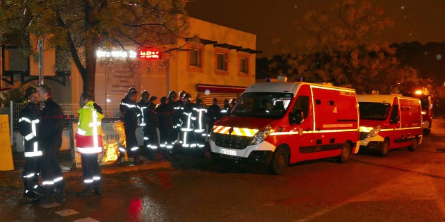 Firefighters and ambulances are seen in the village of Montferrier-sur-Lez, southern France, Friday, Nov. 25, 2016.