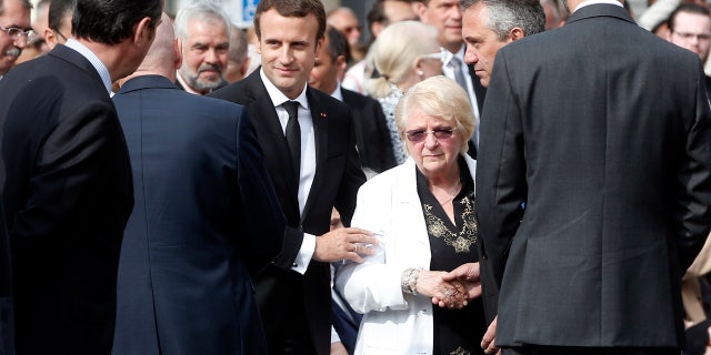 France's President Emmanuel Macron, center left, and sister of French Catholic priest Jacques Hamel, Roselyne, center right, attend a ceremony marking the first anniversary of the killing of French Catholic priest Jacques Hamel.