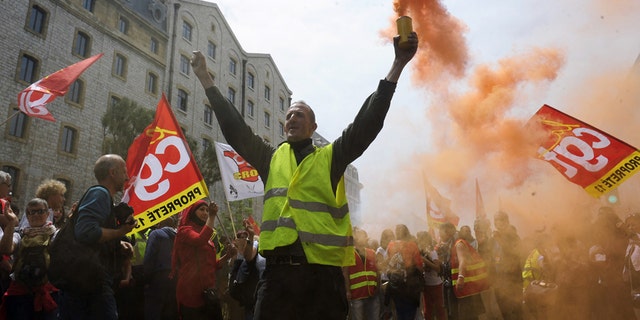 May 26, 2016: A demonstrator burns flares and shouts slogans during a demonstration in Marseille, southern France, on a day of nationwide strikes and protests over a labor reform.