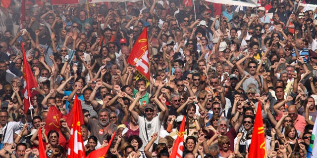 People march during a protest, in Marseille, southern France, Thursday, Sept. 23, 2010. French commuters squeezed onto limited trains or fought for rare parking spots Thursday as a second round of strikes against President Nicolas Sarkozy's plan to raise the retirement age to 62 hobbled trains, planes and schools across the country.