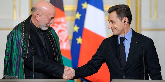 Jan. 27, 2012: Afghan president Hamid Karzai, left, shakes hands with French President Nicolas Sarkozy, right, following a news conference at the Elysee palace in Paris.
