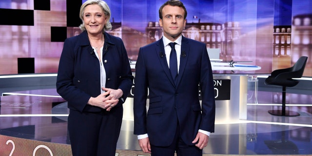 French presidential election candidate for the far-right Front National party, Marine Le Pen, left, and French presidential election candidate for the En Marche ! movement, Emmanuel Macron, pose prior to the start of a live broadcast face-to-face televised debate in La Plaine-Saint-Denis, north of Paris, France, Wednesday, May 3, 2017 as part of the second round election campaign. Pro-European progressive Emmanuel Macron and far-right Marine Le Pen are facing off in their only direct debate before Sunday's presidential runoff election. (Eric Feferberg/Pool Photo via AP)