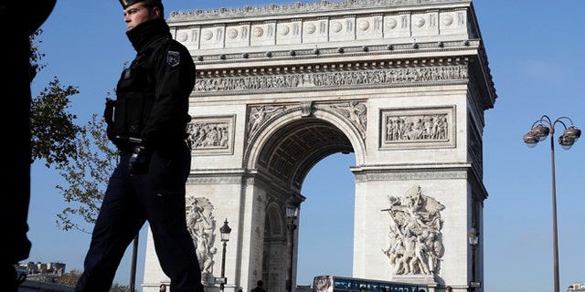 Nov. 23, 2015: A French gendarme officer patrols in front of the Arc de Triomphe, on the Champs Elysees, in Paris.
