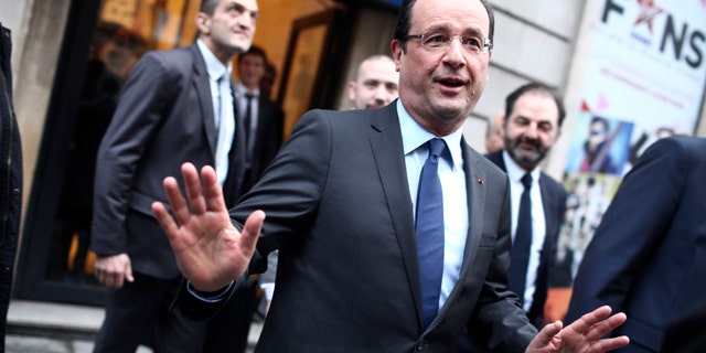 Dec. 21, 2012: France's President Francois Hollande, center, gestures as he leaves the Europe 1 radio station after an interview, in Paris.