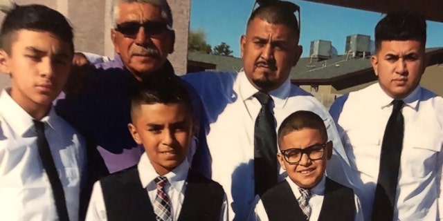 Frank Pineda posing for a photo with members of his family.