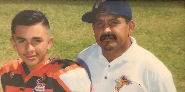 Frank Pineda, right, with his son.