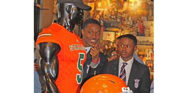 Two students participated in the unveiling of Frederick Douglass High School's Stallions colors and gear Monday.