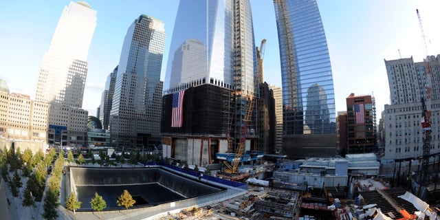 NEW YORK, NY - SEPTEMBER 11: The North Pool of the 9/11 Memorial, with One World Trade Center under construction at rear during the tenth anniversary ceremonies of the September 11, 2001 terrorist attacks at the World Trade Center site, September 11, 2011 in New York City. New York City and the nation are commemorating the tenth anniversary of the terrorist attacks on lower Manhattan which resulted in the deaths of 2,753 people after two hijacked planes crashed into the World Trade Center. (Photo by Robert Deutsch-Pool/Getty Images)