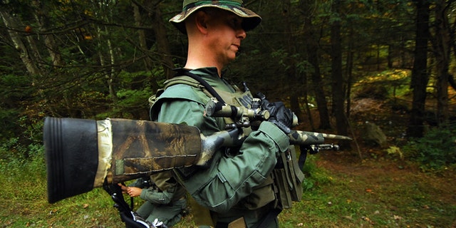 Oct. 2, 2014: A member of the Scranton, Pa., Police Special Operations Group, prepares to search the woods in Barrett Township near Canadensis, Pa., for suspected killer Eric Frein.
