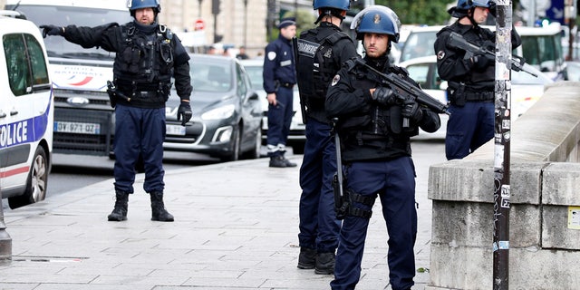 French police stand guard outside Notre Dame Cathedral after a shooting in Paris in June of 2017.